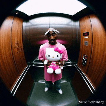 a man in an elevator holding a hello kitty doll