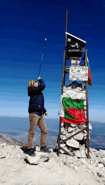 a man stands in front of a sign that says ' bulgarian ' on it