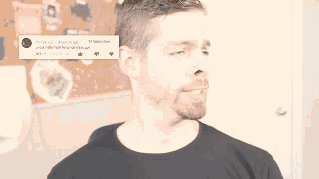 a man in a black shirt is standing in front of a bulletin board with a reply from wolfyle kyle 4 months ago