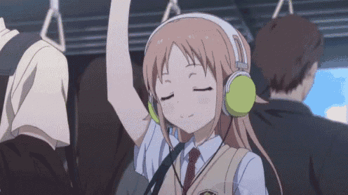 a girl wearing headphones is riding a bus with her eyes closed .