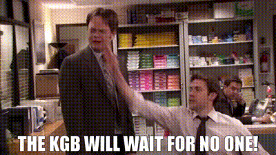 a man in a suit and tie is standing next to another man in a store and says the kgb will wait for no one !
