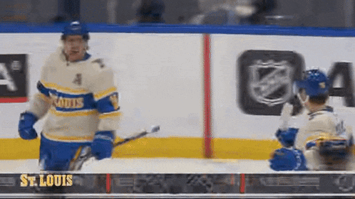 a hockey player wearing a st. louis jersey is standing on the ice