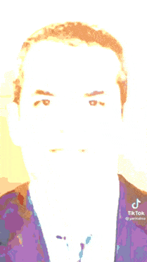 a man in a suit and tie has a tiktok logo on the bottom