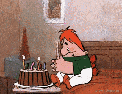 a cartoon character is sitting next to a cake with candles on it