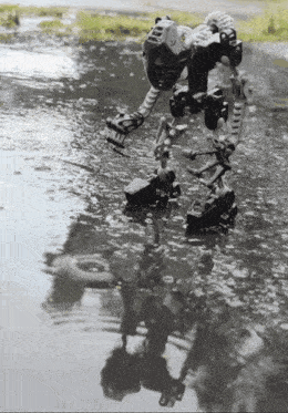 a black and white photo of a robot in the water