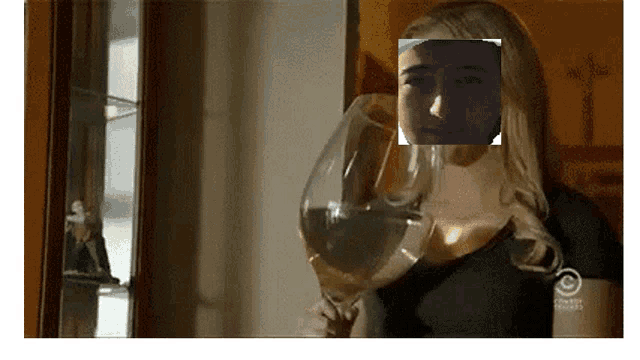 a woman is holding a wine glass with a picture of her face on it ..