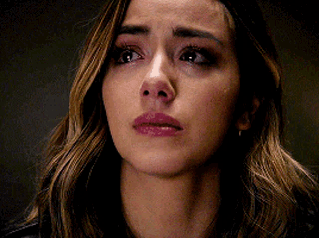 a close up of a woman 's face with her eyes closed and her mouth open .