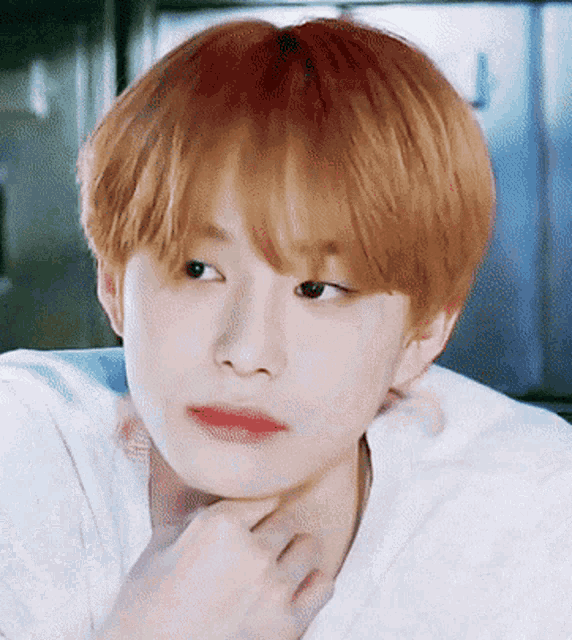 a close up of a young man 's face with red hair