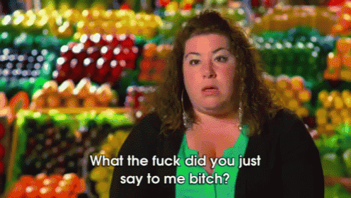 a woman says " what the fuck did you just say to me bitch " in front of a fruit stand