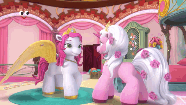 two pink and white ponies standing next to each other