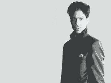 a black and white photo of a man wearing a turtleneck and a pocket square