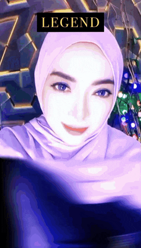 a woman wearing a purple hijab has a legend sticker on her head