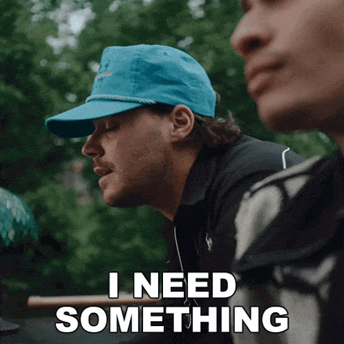a man wearing a blue hat is saying i need something