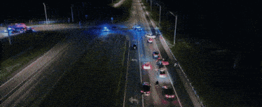 a bunch of police cars are driving down a highway