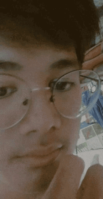 a close up of a person wearing glasses with a reflection of a person in the glasses