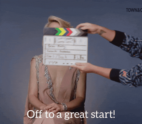 a woman sitting in front of a clapper board with the words off to a great start on the bottom