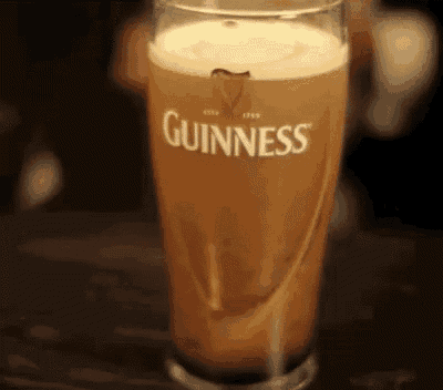 a glass of guinness beer is poured into it