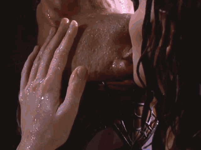 a close up of a person 's face with their hands on it