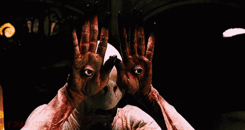 a monster with bloody hands is making a face with his hands