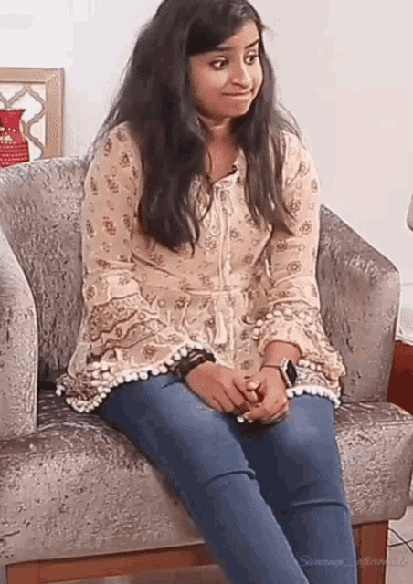 a girl is sitting in a chair with her legs crossed