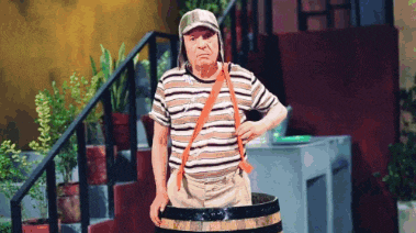 a man in a striped shirt is holding a barrel in front of stairs