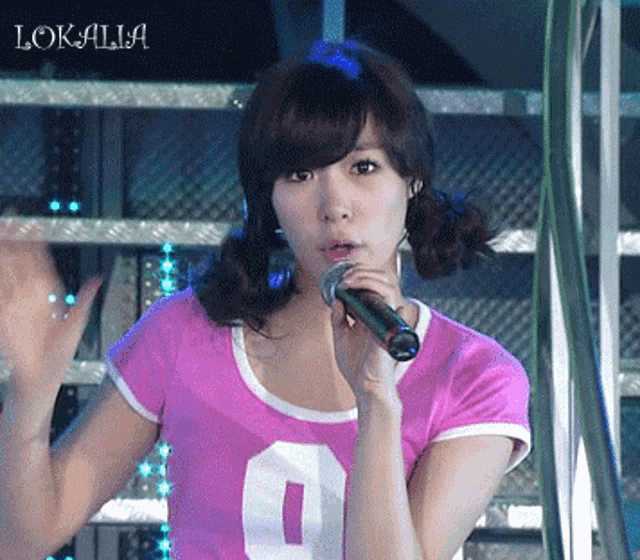 a woman in a pink shirt with the number 9 on it