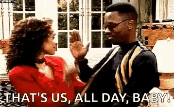 a man and woman are giving each other a high five .