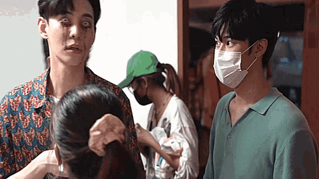 a man with a mask on his face is standing next to a woman