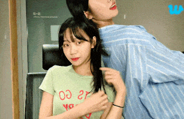 two girls are standing next to each other in front of a window that says 5-2