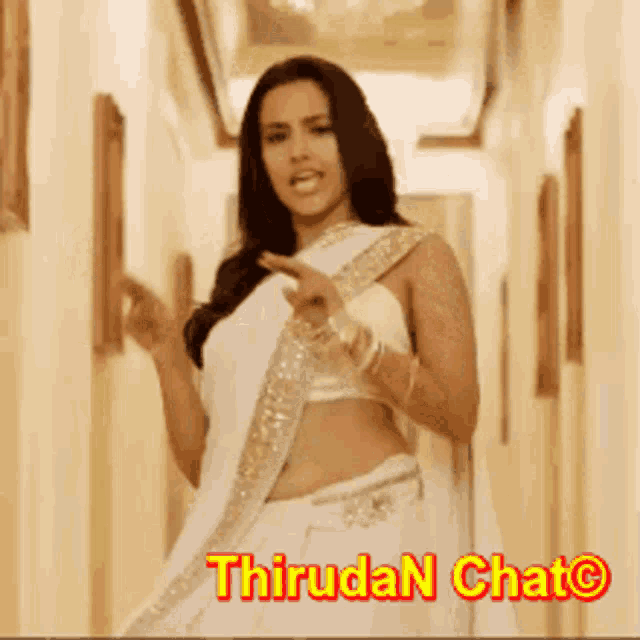 a woman in a white saree is standing in a hallway with the words thiruda n chat on the bottom
