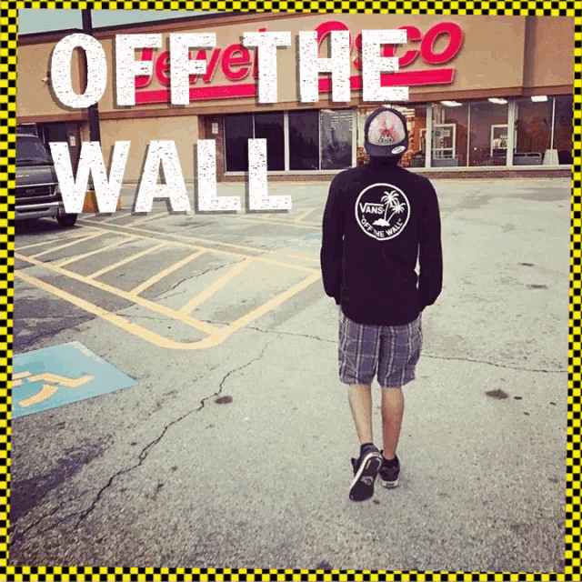 a man wearing a vans sweatshirt is walking in front of a store that says off the wall