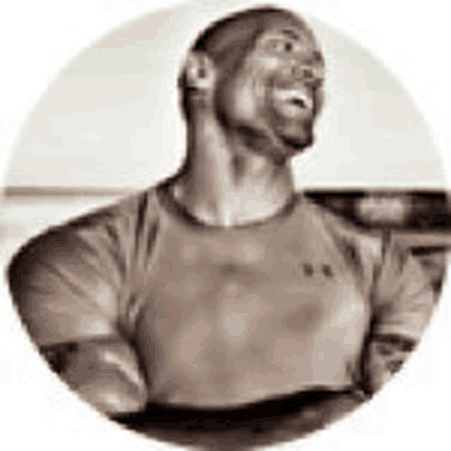 a man in a t-shirt is standing in a circle with his arms crossed and looking up .