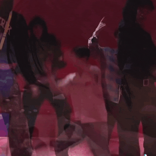 a group of people are dancing in front of a red background with a sign that says " err "