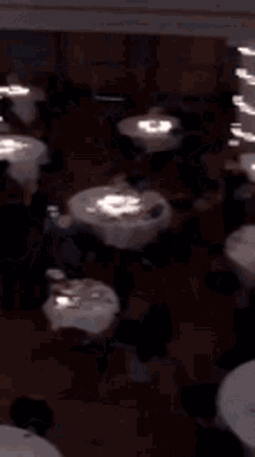 a blurred image of a dining room with tables and chairs