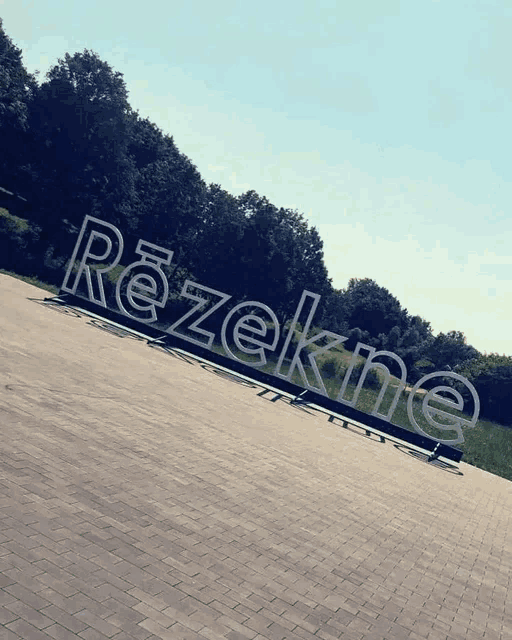 a sign that says rezekne is on a brick walkway