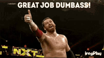 a wrestler is giving a thumbs up in front of a sign that says ' great job dumbass '