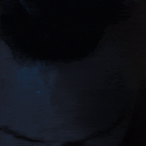 a close up of a man 's face in the dark with his eyes closed