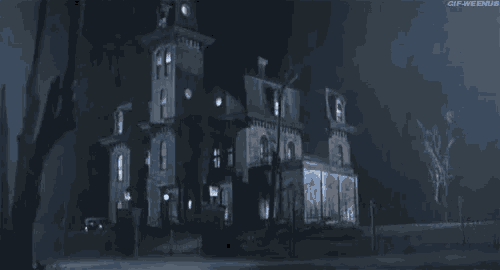 a haunted house is lit up at night with a clock tower