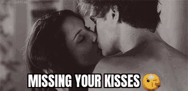 a man and a woman are kissing in a black and white photo with the caption `` missing your kisses '' .