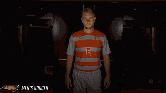 a man in an orange and white striped jersey with the number 6 on it