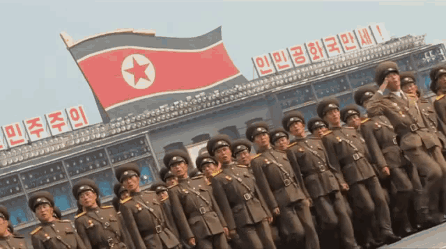 a group of soldiers are standing in front of a sign that says ' a ' on it