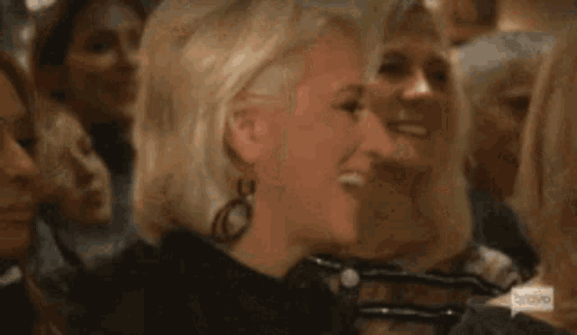a woman says important in front of a crowd of women