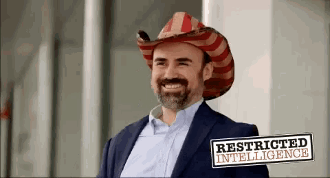 a man wearing a cowboy hat with the words restricted intelligence written on the bottom