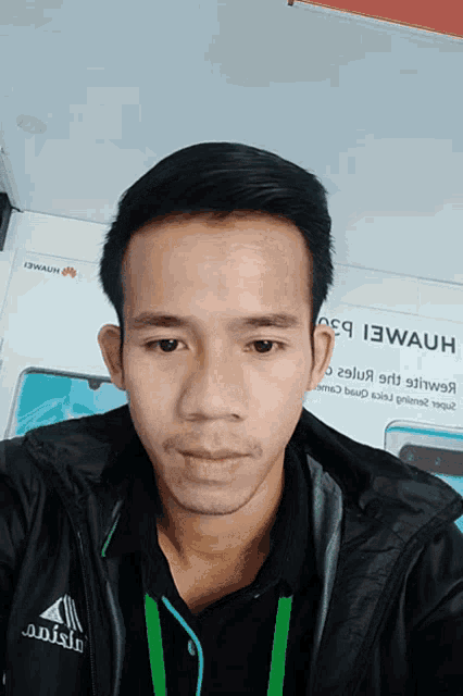 a man is taking a selfie in front of a sign that says 13wauh