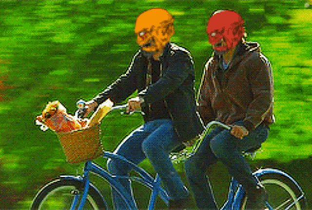 two men wearing masks are riding a bike with a basket full of food