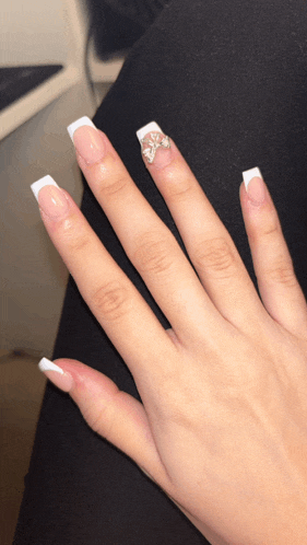 a close up of a woman 's nails with a rhinestone design
