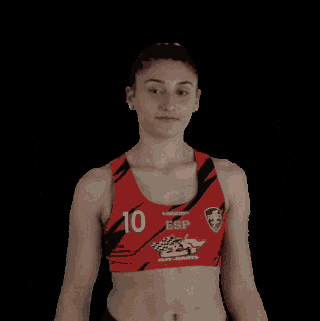 a woman wearing a red top with esp on it