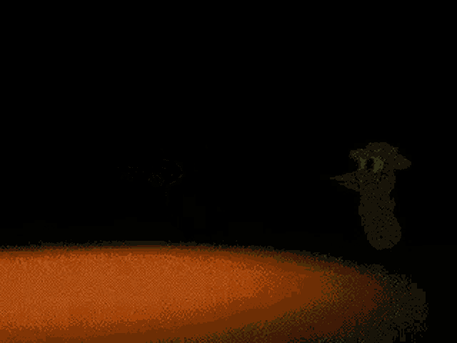 a green cartoon character wearing a cowboy hat is flying through the air in a dark room .