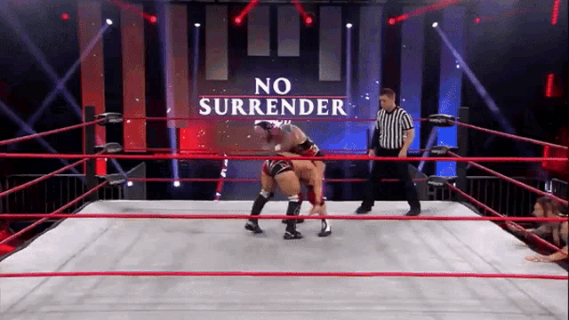 two wrestlers are in a ring with a sign that says " no surrender "