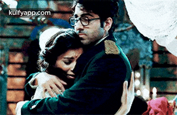 a man and a woman are hugging each other in a movie .